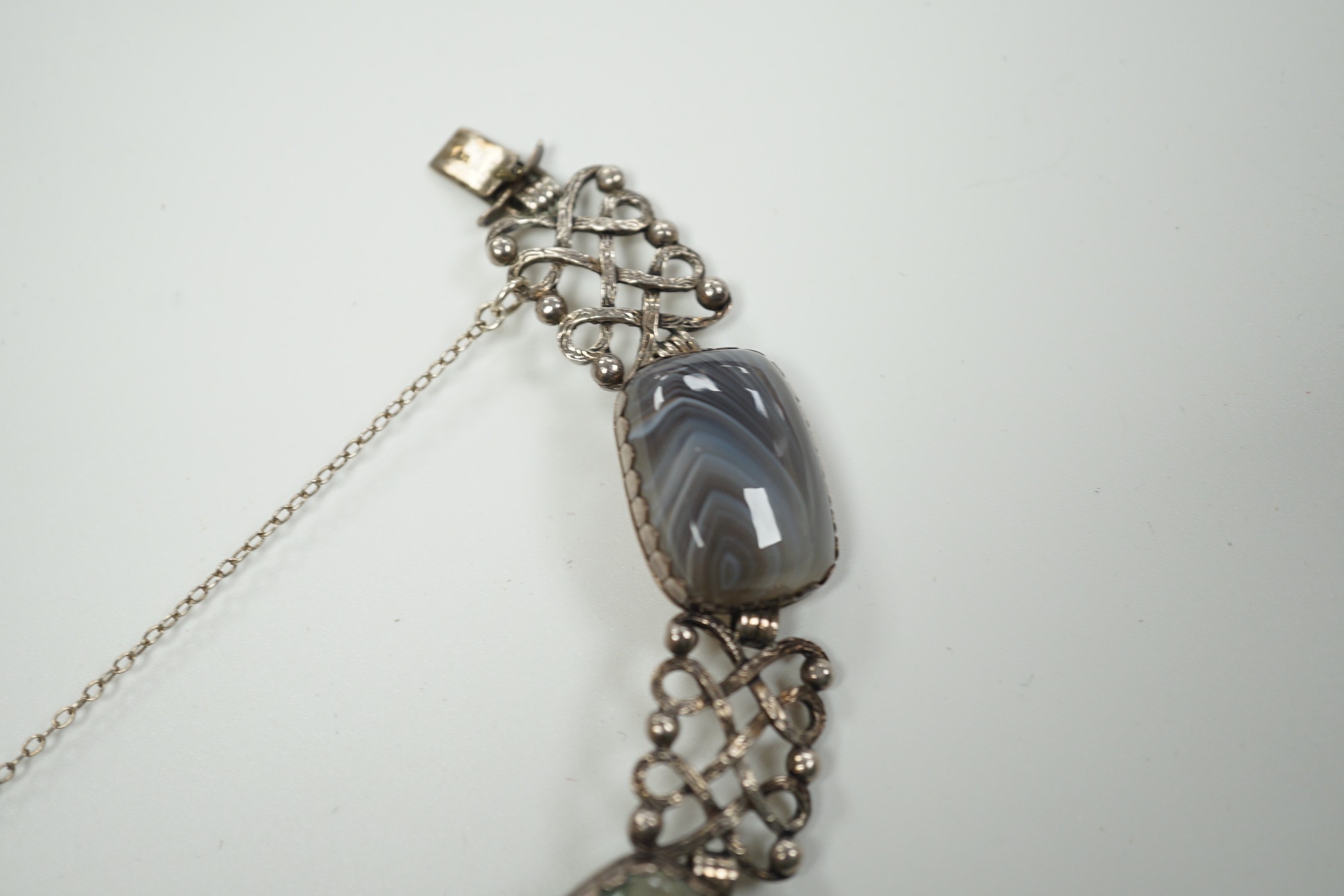 A pierced white metal and four stone agate set bracelet, 18.5cm and a white metal and banded agate set oval pendant.